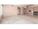 Open living room with neutral walls, a plush area rug, tiled floors, and a cozy fireplace at 24907 S Lakestar Dr, Sun Lakes, AZ 85248