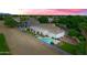 An aerial view shows a swimming pool, patio, tile roof, and landscaping in a suburban neighborhood at 2625 N 24Th St # 22, Mesa, AZ 85213