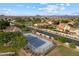 View of a neighborhood tennis and basketball court nestled within mature trees and landscaping at 2625 N 24Th St # 22, Mesa, AZ 85213