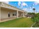 Spacious backyard featuring manicured lawn, covered patio, and fire pit seating area at 2625 N 24Th St # 22, Mesa, AZ 85213