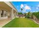 Backyard boasts a covered patio with dining, fire pit area, and lush landscaping at 2625 N 24Th St # 22, Mesa, AZ 85213