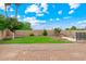 The backyard features a brick patio, lush lawn, and mature landscaping for outdoor enjoyment at 2625 N 24Th St # 22, Mesa, AZ 85213