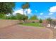 Spacious backyard boasts brick patio, mature landscaping, and privacy for outdoor living and entertaining at 2625 N 24Th St # 22, Mesa, AZ 85213