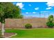 The well-maintained backyard features a lush lawn and mature landscaping for privacy and beauty at 2625 N 24Th St # 22, Mesa, AZ 85213