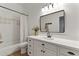 Bright bathroom features a tub with a stylish tile accent wall and an elegant vanity at 2625 N 24Th St # 22, Mesa, AZ 85213