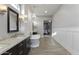 A bright bathroom showcasing the tub, vanity, chandelier, and a doorway to the bedroom at 2625 N 24Th St # 22, Mesa, AZ 85213