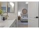 Bathroom featuring a vanity area with modern fixtures; a look through to a cozy bedroom at 2625 N 24Th St # 22, Mesa, AZ 85213