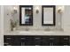 This primary bathroom offers a dual vanity with a marble countertop and stylish black cabinetry at 2625 N 24Th St # 22, Mesa, AZ 85213