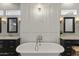 Chic bathroom design featuring a soaking tub, elegant chandelier, and marble countertop vanities at 2625 N 24Th St # 22, Mesa, AZ 85213