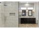 Bathroom showcasing walk-in shower with tile surround and a dual sink vanity with marble counters at 2625 N 24Th St # 22, Mesa, AZ 85213