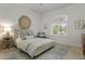 Serene bedroom with a plush bed, an arched window, and a calming neutral color scheme at 2625 N 24Th St # 22, Mesa, AZ 85213