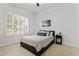 Well-lit bedroom with a queen-sized bed, shuttered windows, and neutral decor with an accent painting at 2625 N 24Th St # 22, Mesa, AZ 85213