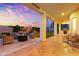 Covered patio with stone flooring, comfortable seating, outdoor kitchen, and string lights at sunset at 2625 N 24Th St # 22, Mesa, AZ 85213