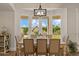 Bright dining room features a backyard view, decorative chandelier, and a stylish table set for six at 2625 N 24Th St # 22, Mesa, AZ 85213