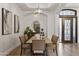 Dining room with a tray ceiling, modern light fixture and an ornate decorative glass door at 2625 N 24Th St # 22, Mesa, AZ 85213