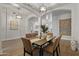 Dining area with arched openings, stylish light fixtures, and views to multiple rooms at 2625 N 24Th St # 22, Mesa, AZ 85213