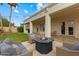 Cozy backyard with an outdoor fireplace, built-in grill, and manicured landscaping at 2625 N 24Th St # 22, Mesa, AZ 85213