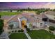 Single-story home at sunset features lush landscaping, a well-manicured lawn, and an inviting entrance at 2625 N 24Th St # 22, Mesa, AZ 85213