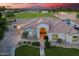 Inviting single-story home features lush landscaping, a well-manicured lawn, and an inviting entryway at sunset at 2625 N 24Th St # 22, Mesa, AZ 85213