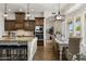 Open-concept kitchen and dining area with granite counters, a center island, and a seating area at 2625 N 24Th St # 22, Mesa, AZ 85213