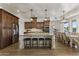 Kitchen island with granite counters, seating, and view to the dining area at 2625 N 24Th St # 22, Mesa, AZ 85213