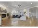Open living room with a stone fireplace, ceiling fan, and modern decor at 2625 N 24Th St # 22, Mesa, AZ 85213