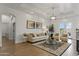 Bright living room with hardwood floors, neutral tones, and decorative light fixture at 2625 N 24Th St # 22, Mesa, AZ 85213