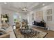 Bright living room with tray ceilings, modern lighting, and French doors to the outdoors at 2625 N 24Th St # 22, Mesa, AZ 85213