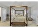 Luxurious main bedroom with a four-poster bed, soft lighting, and neutral decor at 2625 N 24Th St # 22, Mesa, AZ 85213