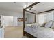 Relaxing main bedroom featuring a four-poster bed, neutral colors, and ensuite bathroom access at 2625 N 24Th St # 22, Mesa, AZ 85213