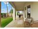 Relaxing covered patio features an outdoor kitchen, wicker furniture and manicured lawn at 2625 N 24Th St # 22, Mesa, AZ 85213