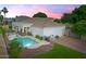 Backyard view with a swimming pool, spa, tile roof, an outdoor lounge area and professional landscaping at 2625 N 24Th St # 22, Mesa, AZ 85213