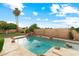 The pool has rock accents and water features in the backyard for a relaxing and fun experience at 2625 N 24Th St # 22, Mesa, AZ 85213