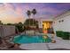 Backyard with a stunning pool and spa is beautifully illuminated at twilight for a relaxing ambiance at 2625 N 24Th St # 22, Mesa, AZ 85213