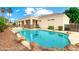 Backyard oasis with a sparkling pool, rock features, and covered patio, perfect for outdoor entertaining and relaxation at 2625 N 24Th St # 22, Mesa, AZ 85213