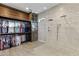 Spacious walk-in closet with custom wood shelving and hanging rods next to a luxurious shower at 2625 N 24Th St # 22, Mesa, AZ 85213