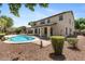 Expansive backyard showcasing a private pool, covered patio, mature trees, and beautiful landscaping elements at 2648 E Teakwood Pl, Chandler, AZ 85249
