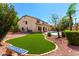 Beautiful backyard featuring lush grass, decorative stone and home in background at 2648 E Teakwood Pl, Chandler, AZ 85249