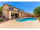 Backyard pool and covered patio with columns offer an ideal space for outdoor entertaining and relaxation at 2648 E Teakwood Pl, Chandler, AZ 85249