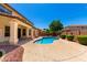 Resort-style backyard showcases a sparkling pool, covered patio, and meticulously manicured landscaping at 2648 E Teakwood Pl, Chandler, AZ 85249