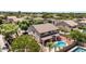 Aerial view of home's back exterior with covered patio, swimming pool, landscaping, and a privacy fence at 2648 E Teakwood Pl, Chandler, AZ 85249
