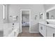 Bright bathroom featuring a soaking tub, double sinks, and modern lighting at 2648 E Teakwood Pl, Chandler, AZ 85249