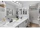 A luxurious bathroom with double vanity, stylish mirrors, and modern fixtures at 2648 E Teakwood Pl, Chandler, AZ 85249