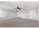 Spacious bedroom with neutral paint, carpet and ceiling fan, providing a blank canvas at 2648 E Teakwood Pl, Chandler, AZ 85249