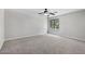Bright bedroom with neutral carpet and paint, and large windows with outside view at 2648 E Teakwood Pl, Chandler, AZ 85249