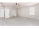 Large, carpeted bedroom showcasing two entry doors and a ceiling fan at 2648 E Teakwood Pl, Chandler, AZ 85249