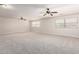 Expansive bonus room with plush carpeting and multiple windows, providing ample natural light at 2648 E Teakwood Pl, Chandler, AZ 85249