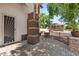 View of front porch with stone column base and iron gate. A door with decorative sunburst design is seen at 2648 E Teakwood Pl, Chandler, AZ 85249
