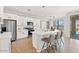 Spacious kitchen with white cabinets, stainless steel appliances, a breakfast bar, and outdoor access at 2648 E Teakwood Pl, Chandler, AZ 85249