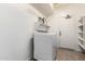 Laundry room featuring a new washer and dryer, built in shelving and tile floors at 2648 E Teakwood Pl, Chandler, AZ 85249